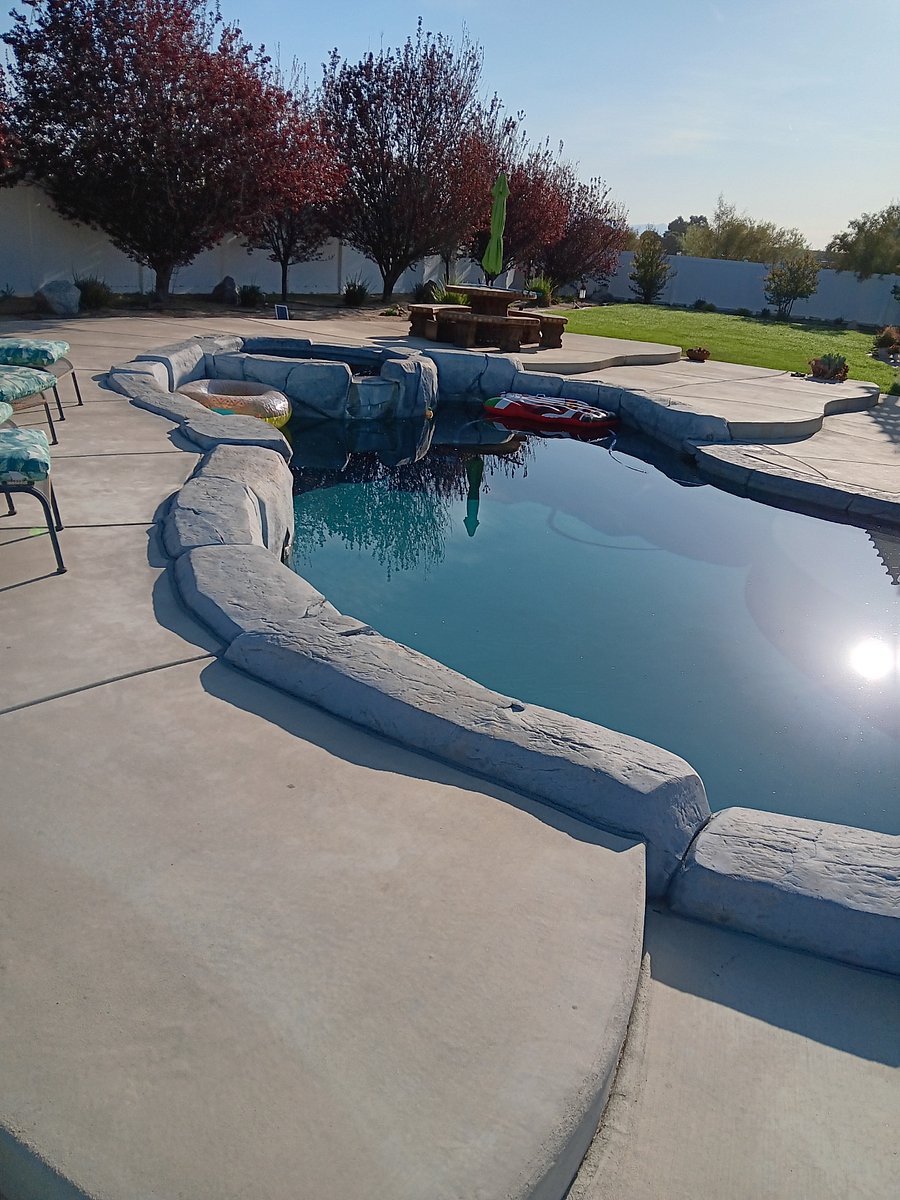 Large back yard with pool and hot tub.