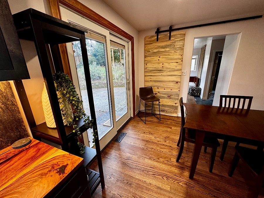 A custom sliding barn door separates the dining room from the 2nd office space, bathroom, and laundry.
