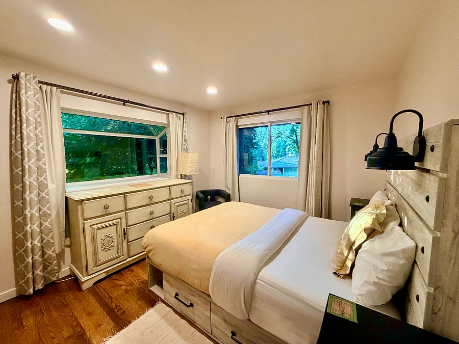 This bedroom has a queen bed and an unpictured armoire for additional clothes storage.