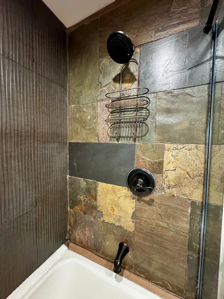 Beautiful slate surrounds the tub.