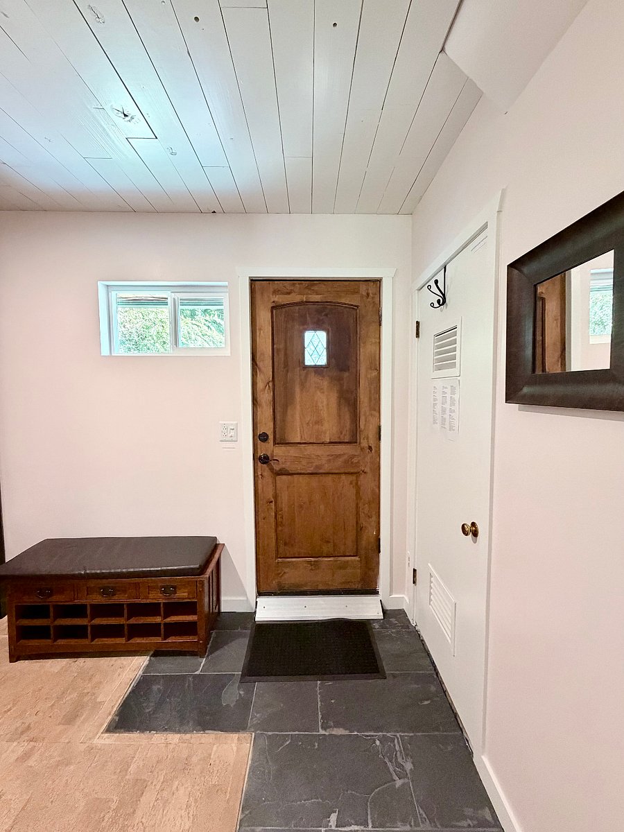 Door from the gear room to the driveway. There is also additional storage space and space for hanging clothes/coats/gearF in this room.