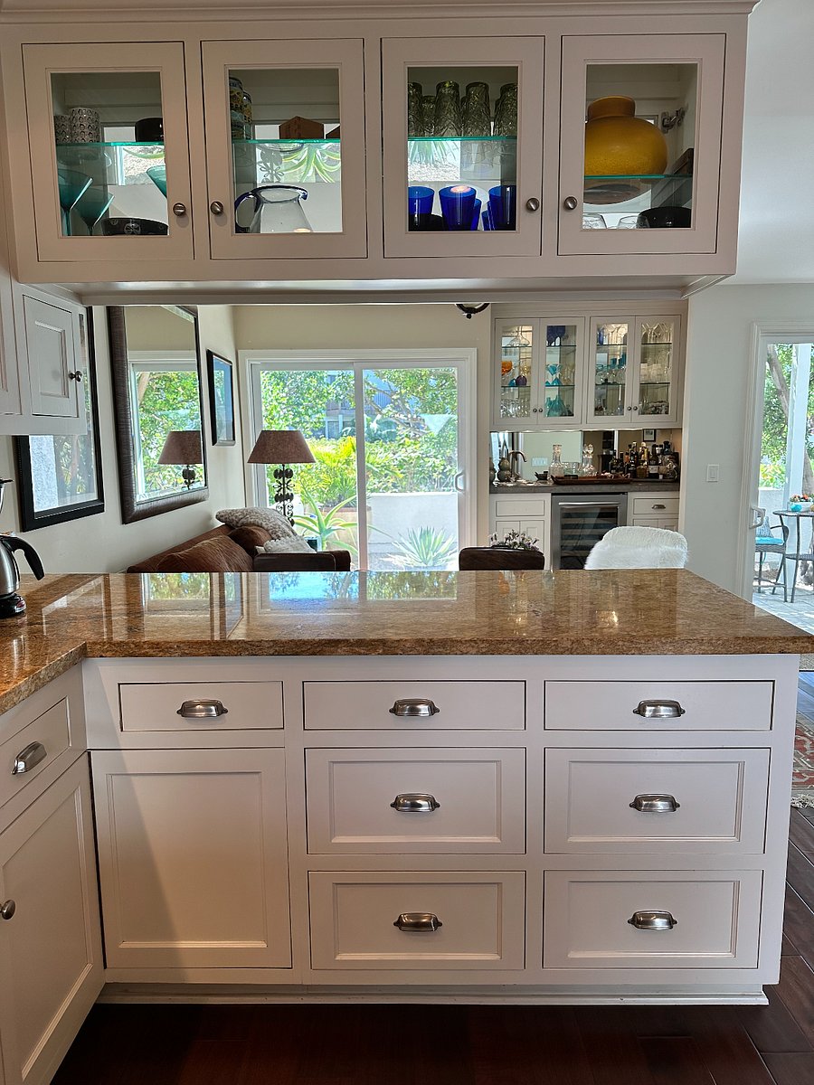 kitchen counter, step up living room sitting area, bar & view of  the patio