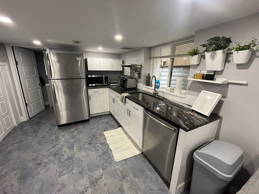 Kitchen features a full-size fridge/freezer, convection/microwave oven, toaster oven/air fryer, disposal and dishwasher.