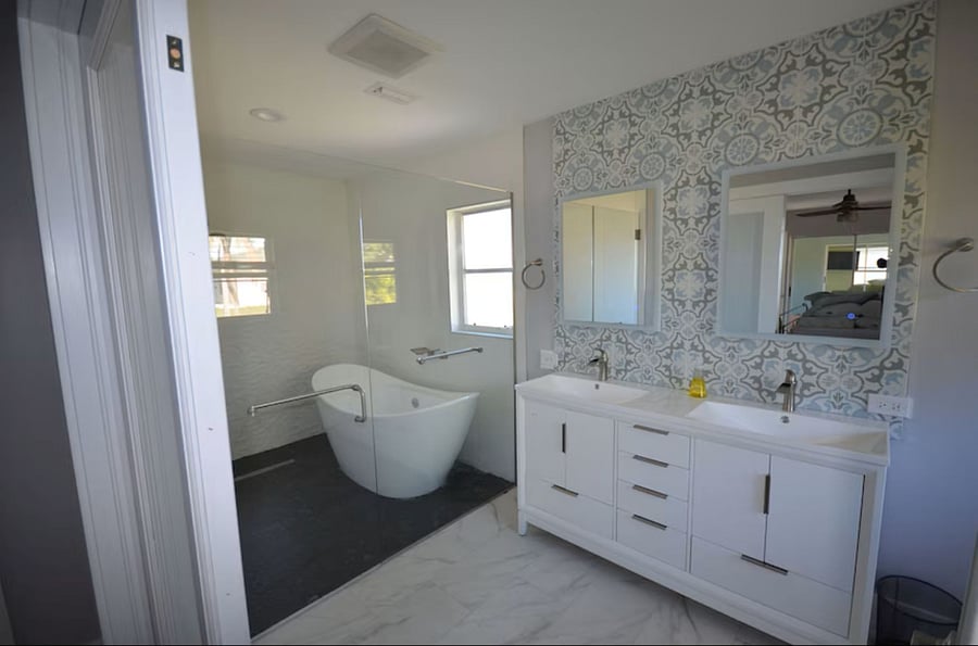 Smooth stone floor in wet room, hair dryer and extra towels