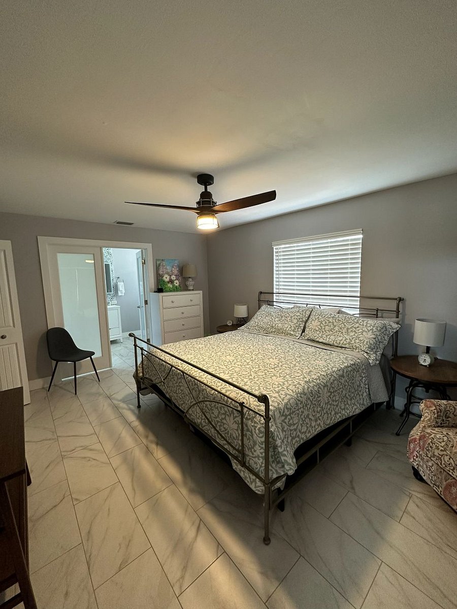 King size bed, large screen television, arm chair and sitting chair, walk-in closet