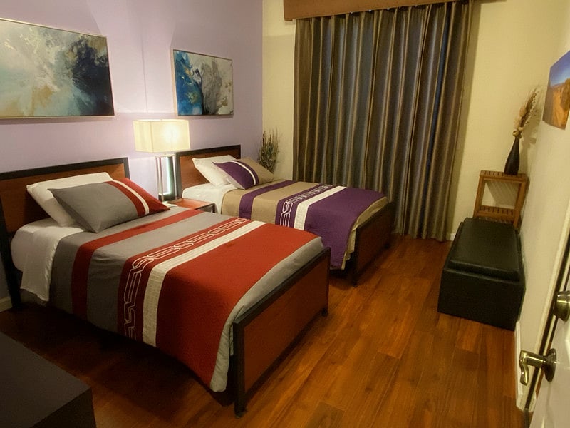 Guest Bedroom with Two Twin Beds and Sliding Door Access to Front and Backyard