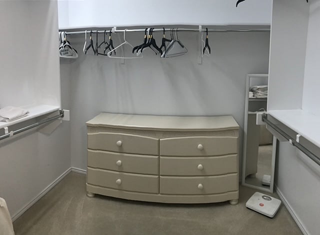 Walk-in closet with full dresser for clothing.  Extra towels are located nearby for easy access to bath area