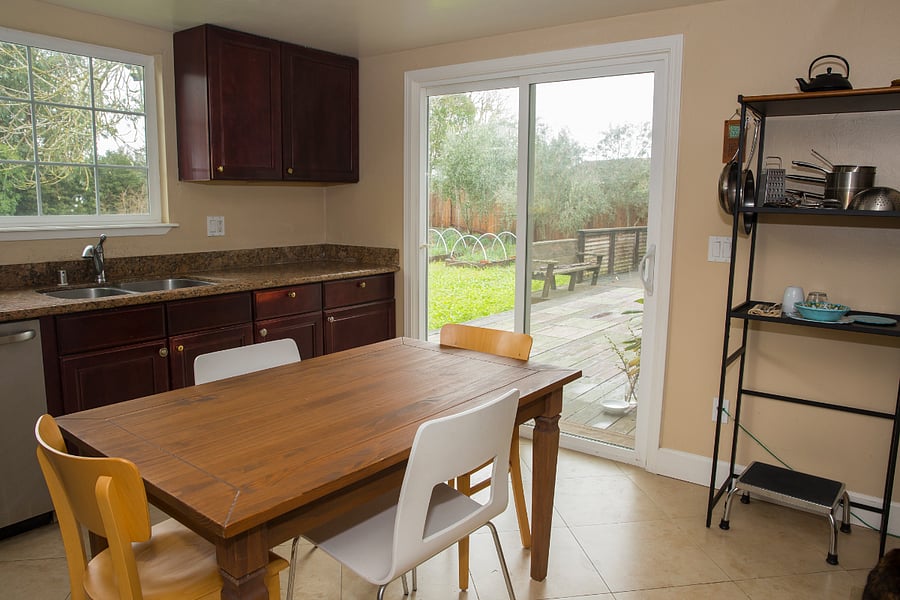 Kitchen, table, view to outside deck.