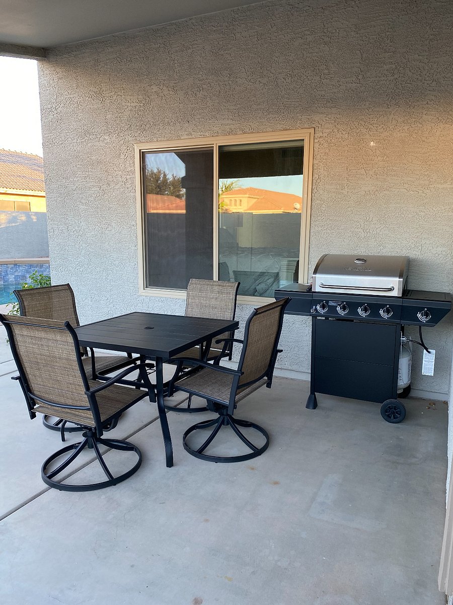 Patio with 4 swivel/rocking chairs, table and gas BBQ