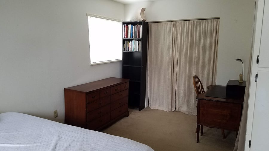 Primary Bedroom view of desk and one of 2 closets. (the bed is in the foreground and the dresser is the same as shown in pic of Queen bed.