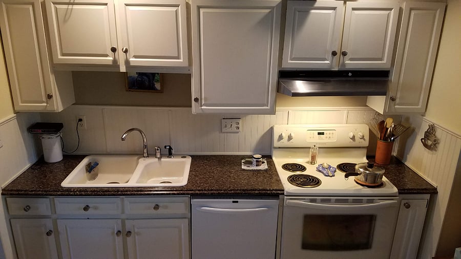 Kitchen double sink, dishwasher and electric stove/oven. view 1