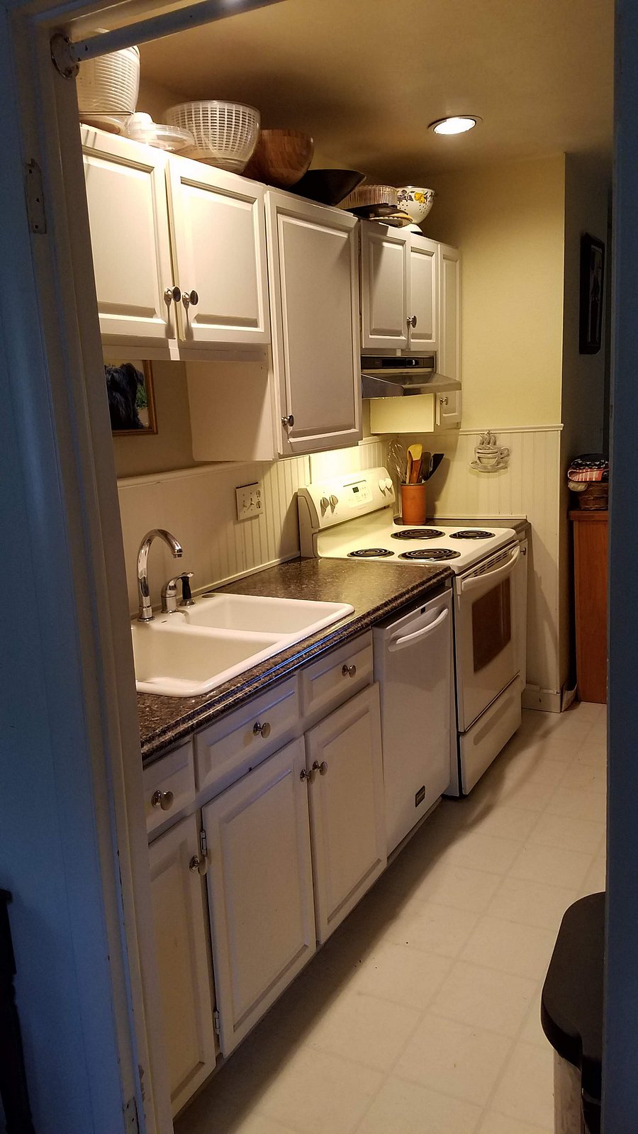 Kitchen double sink, dishwasher and electric stove/oven. view 2