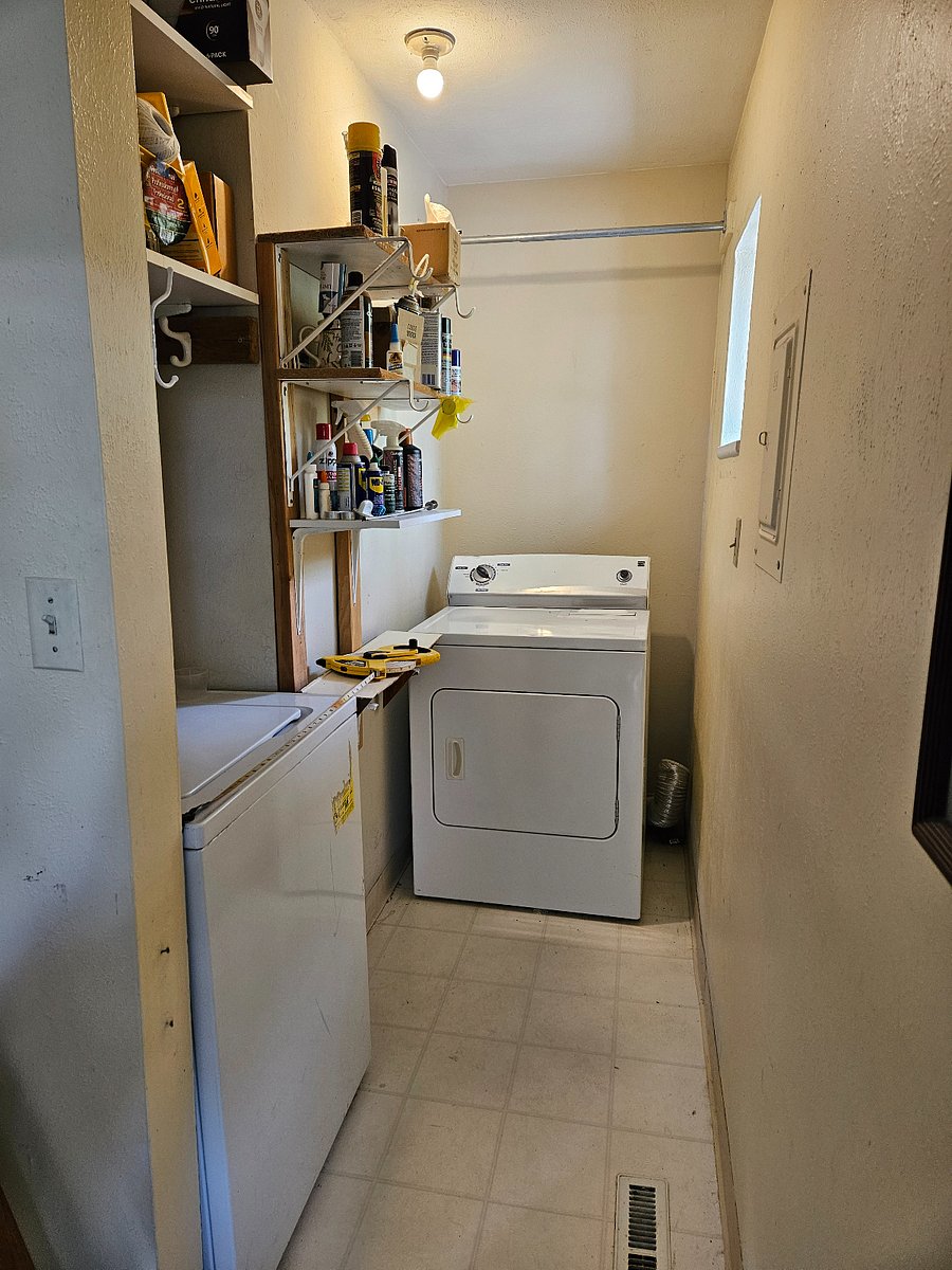 Off the kitchen is a small alcove with a washer and dryer.