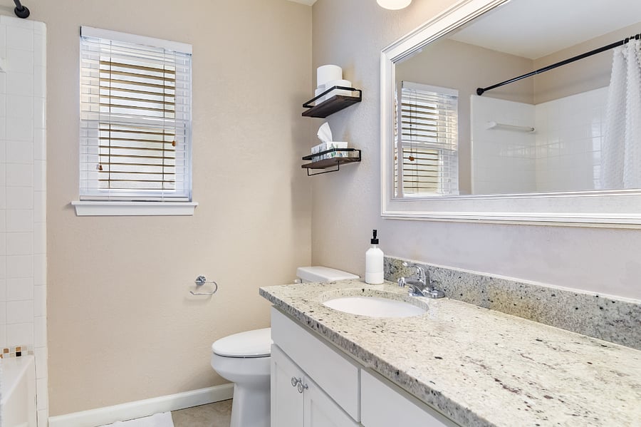 Full hall bathroom with bathtub/shower combo and plenty of storage