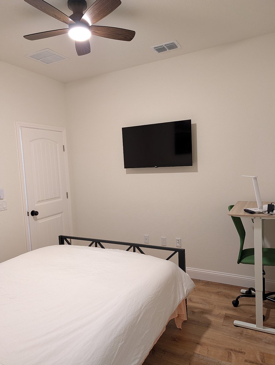 one of two smaller bedrooms, queen bed, electric motor adjustable desk, large closet, TV