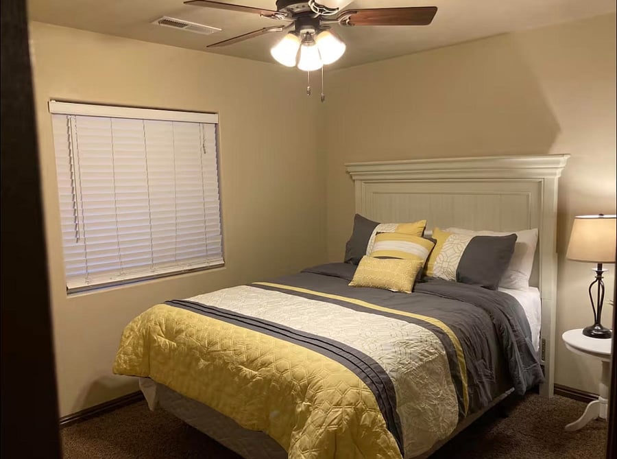 Cozy bedroom with plush queen bed and natural light