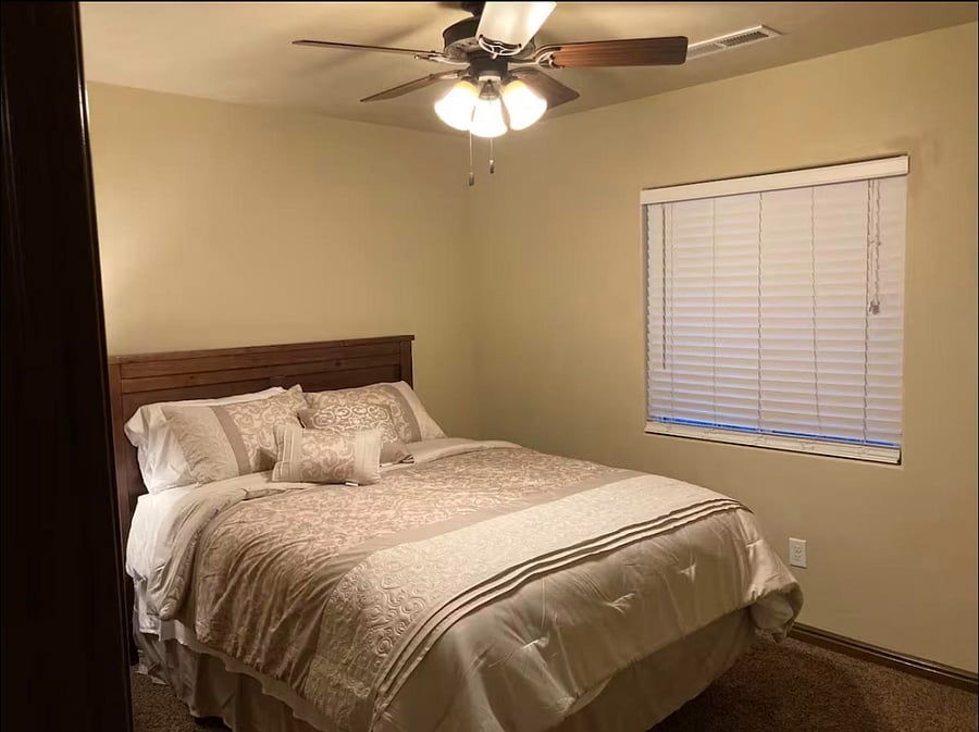 Spacious bedroom with queen bed and large window