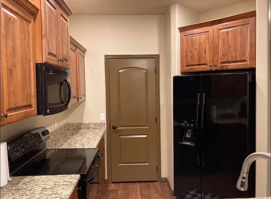 Kitchen with full-size fridge and generous cabinet storage