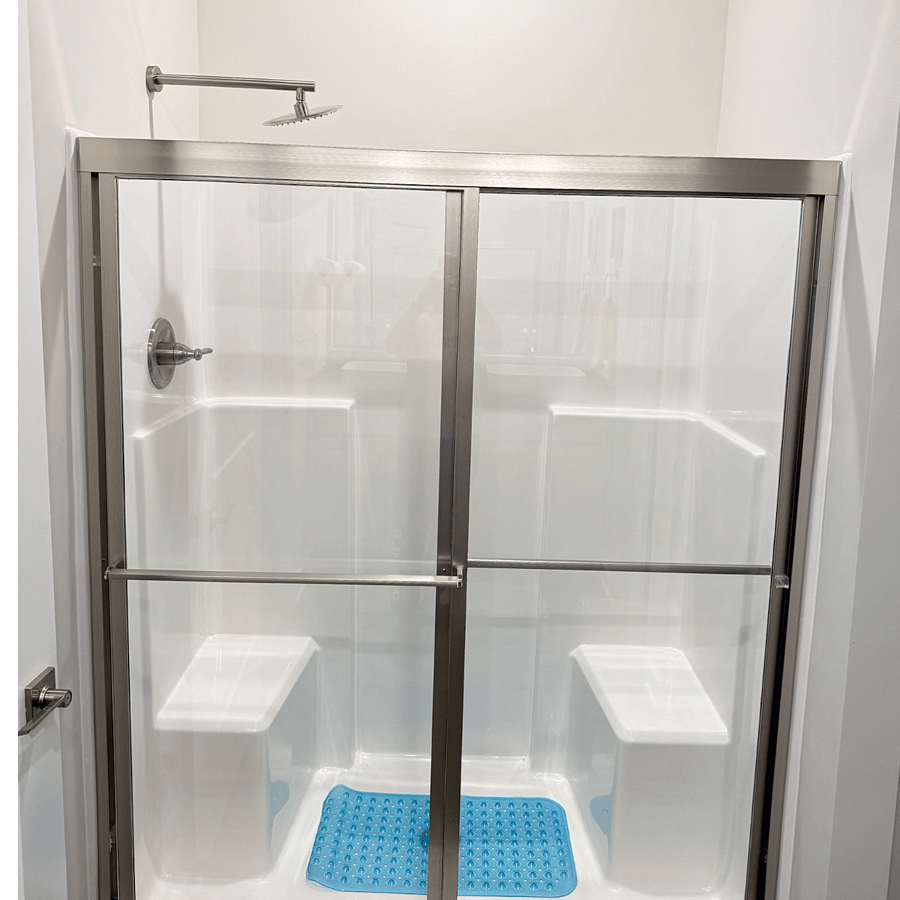 Private bath features a rain shower.