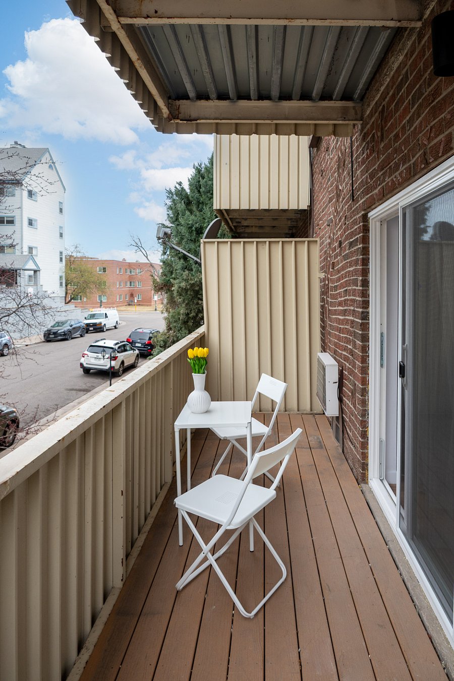 large outdoor balcony with table and chairslay