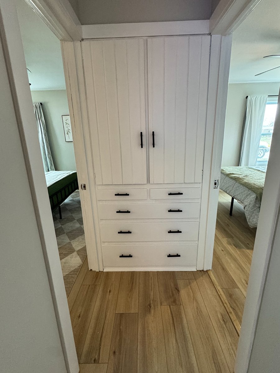View of hallway with storage and both bedrooms