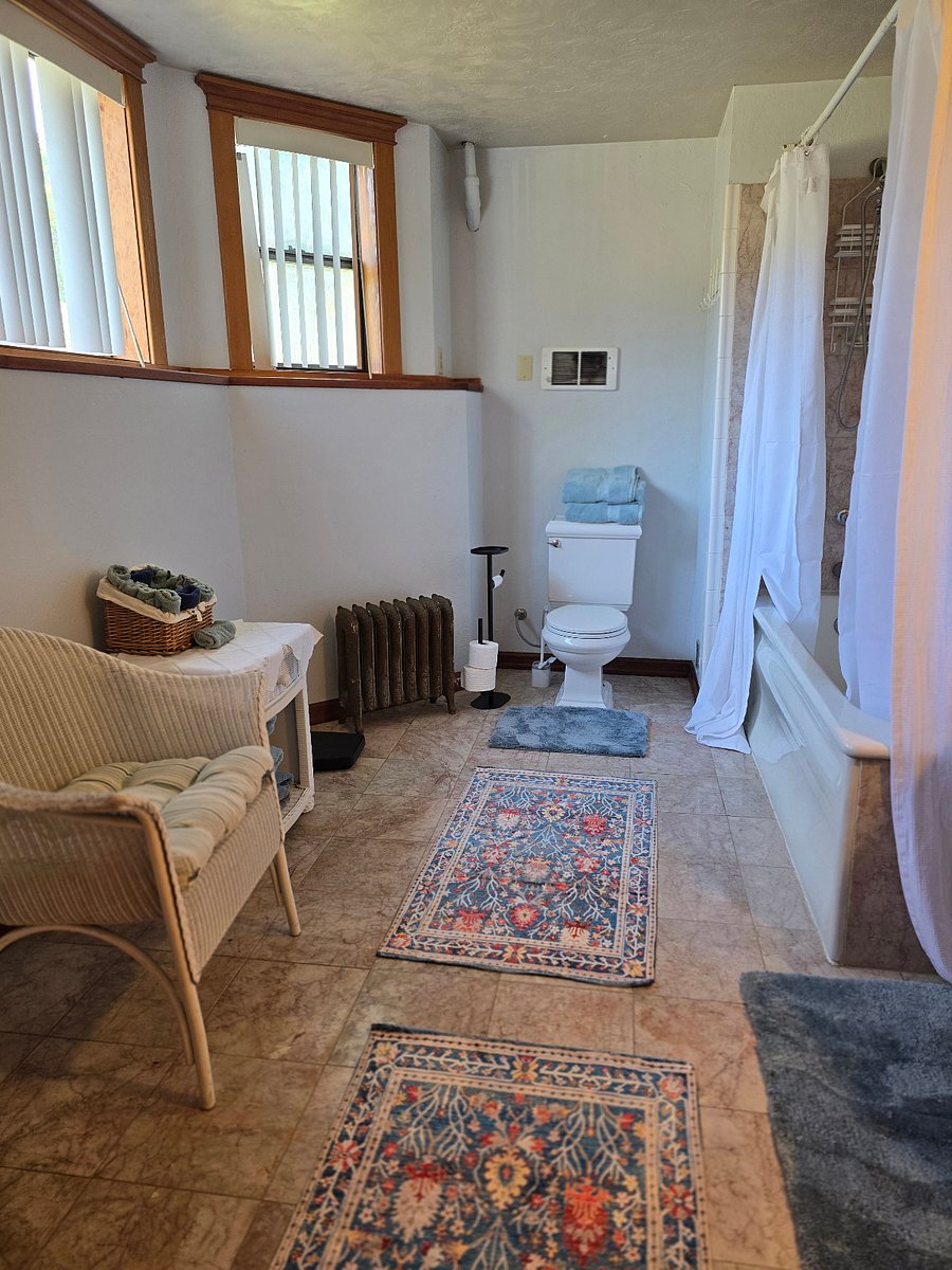 Bathroom off of main bedroom. Oversize tub with shower. Pedestal sink and custom marble flooring.