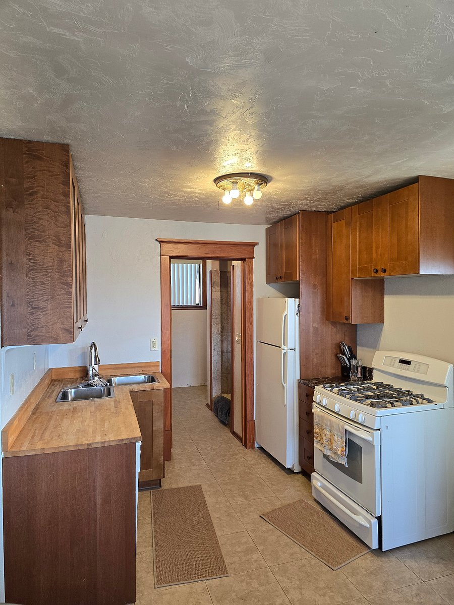 Kitchen leads on to the second bathroom with shower/ corner toilet, pedestal siznk and full size laundry room with extra storage space. 