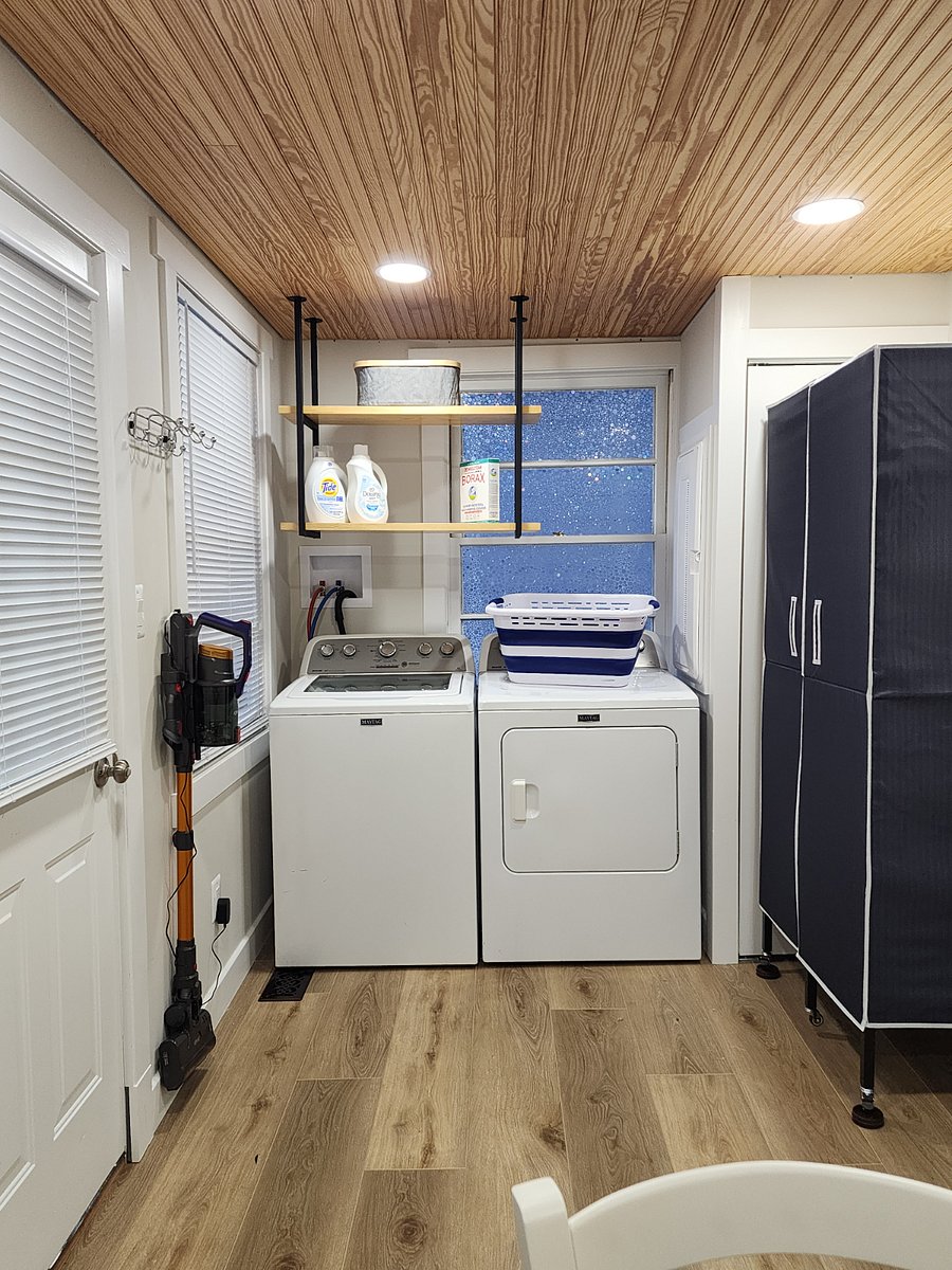 Laundry area with extra storage for clothing.