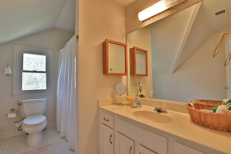 Shared full bathroom with shower and tub 