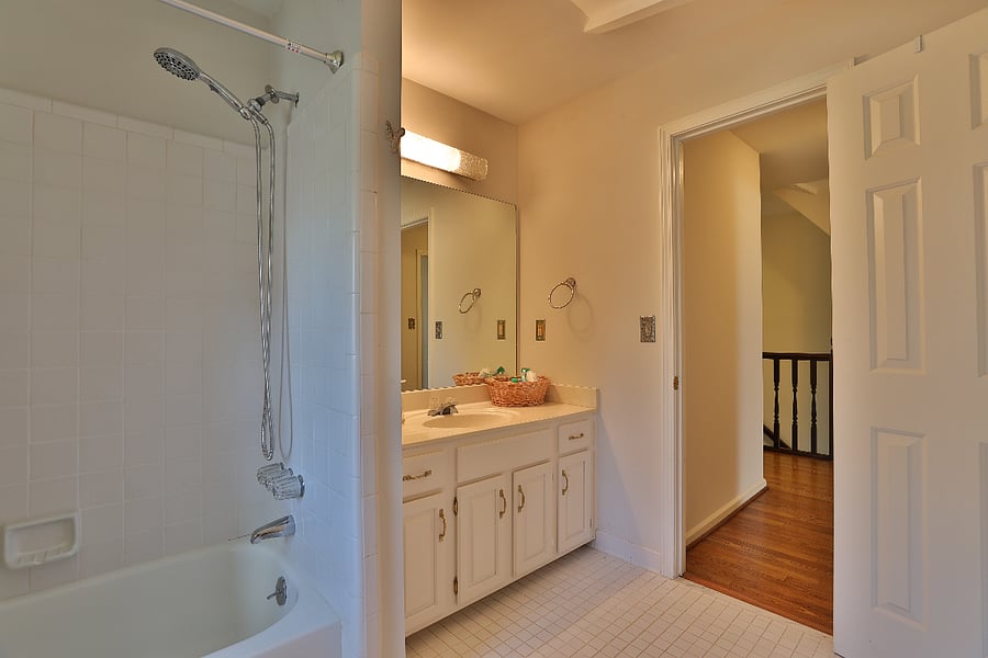 Shared full bathroom with shower and tub 