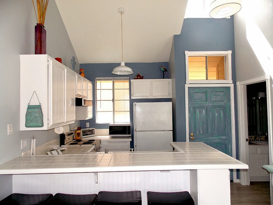 Spacious kitchen with ample storage space, full size refrigerator, microwave, toaster, coffee maker, electric stove.
