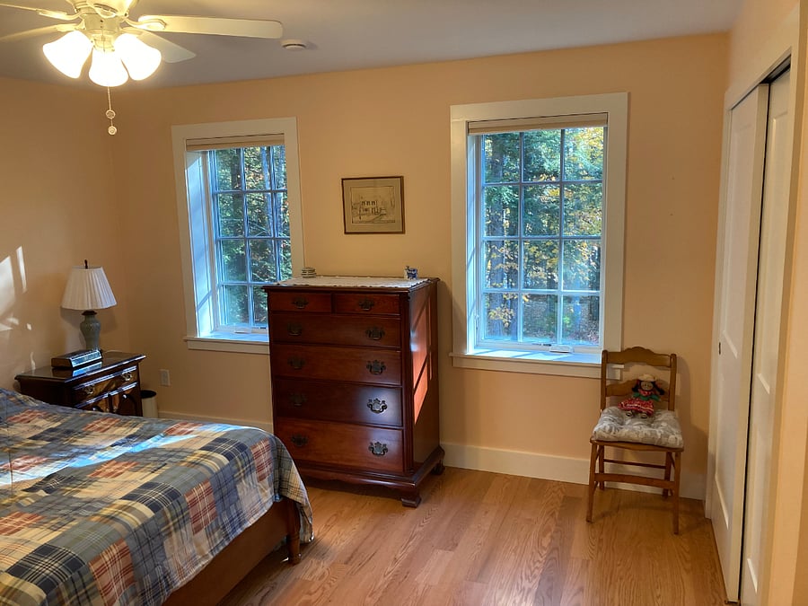 Windows from bedroom to wooded backyard on river