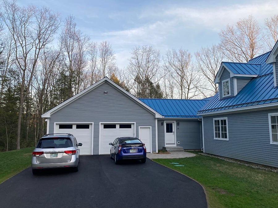 Driveway. Unit is hidden behind the garage