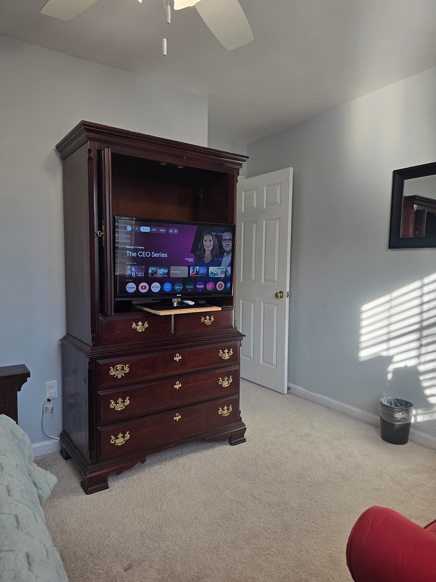 Queen Serta bed with Full-sized Memory Foam Sofa Sleeper + 32" TV on pullout shelf. Smart lighting in ceiling fan and lamp.
