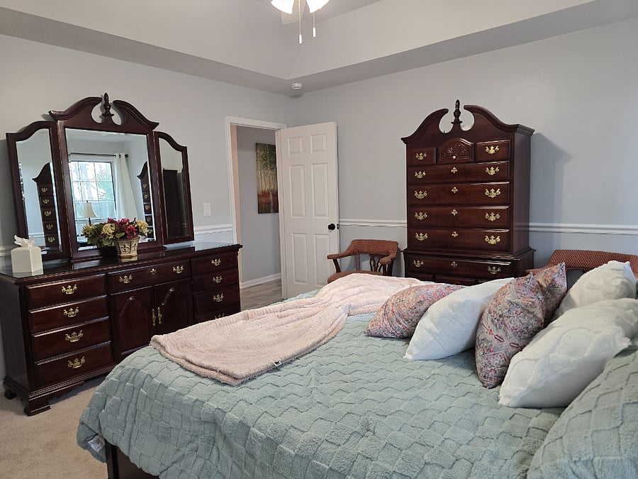 Main bedroom with 42" Smart TV, smart ceiling fan lights, smart lamps, and en-suite bathroom.