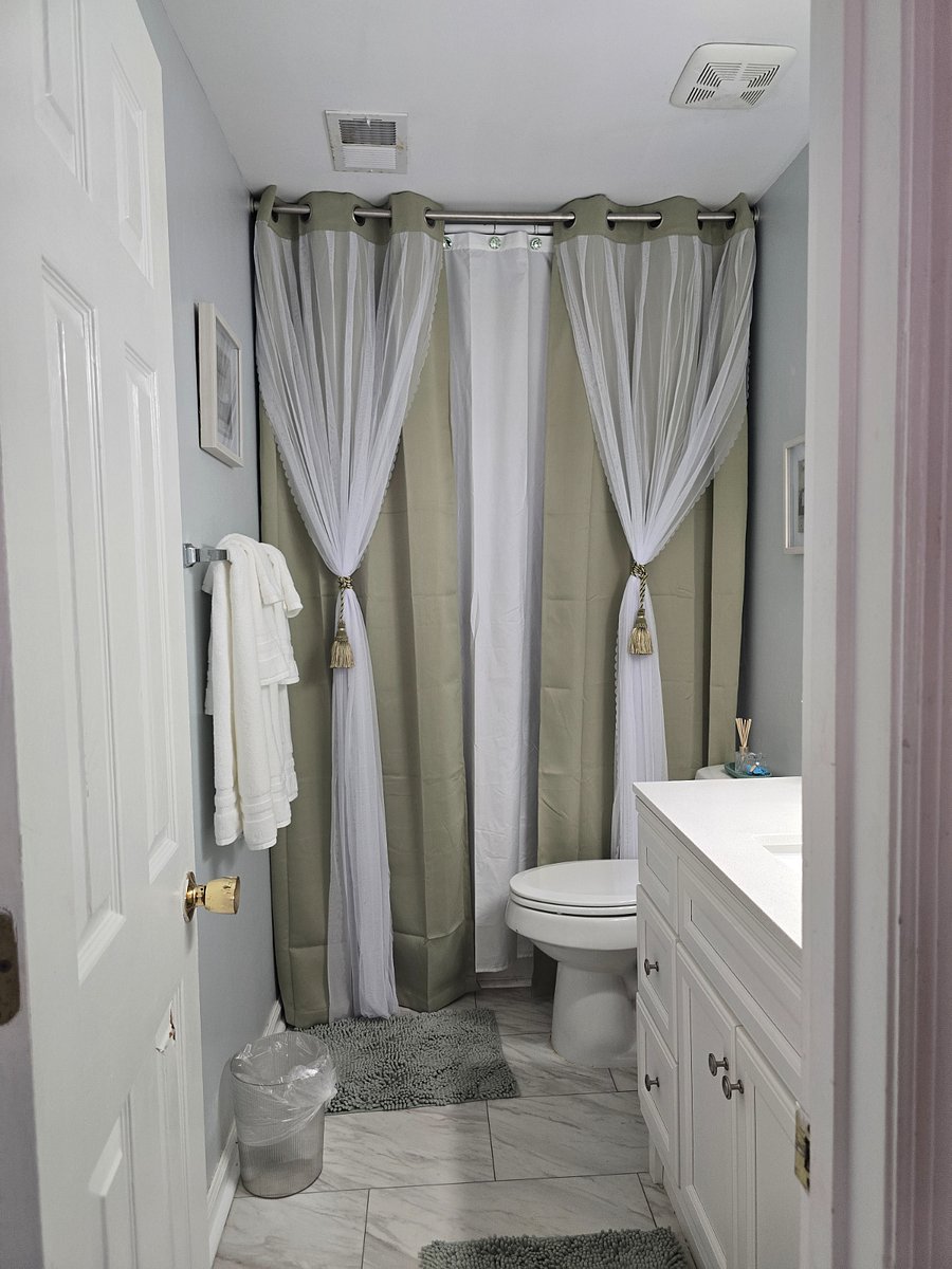 Hall Bathroom.  Linen closet with iron and hair dryer are is behind door.