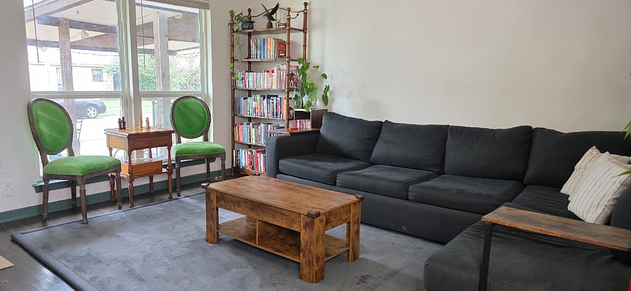 Living Room with extra large sofa, lift top coffee table for couch dining, additional seating and chess board