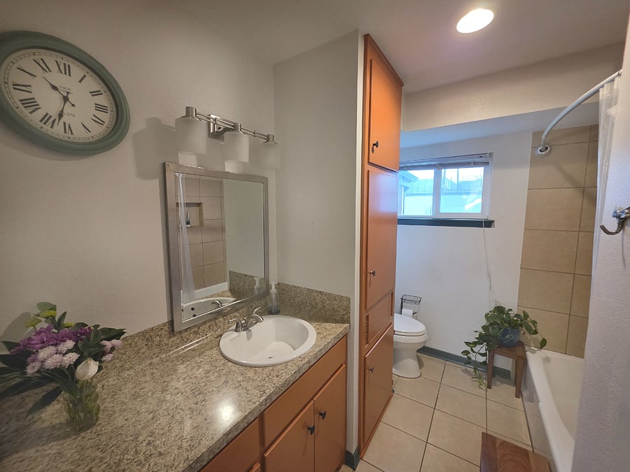Large Full Bathroom with built in laundry hamper at Pecan Porch Retro Retreat