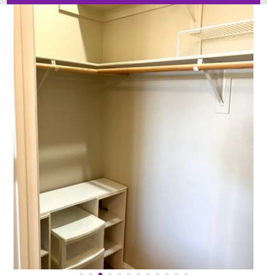 This walk-in closet is next to the bed