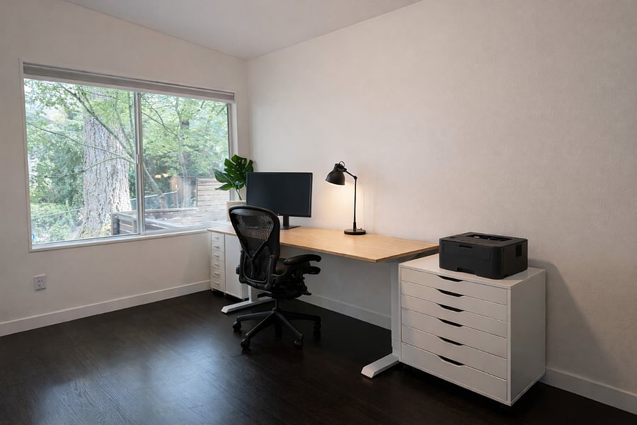 office with erasable whiteboard in the back with printer and monitor
