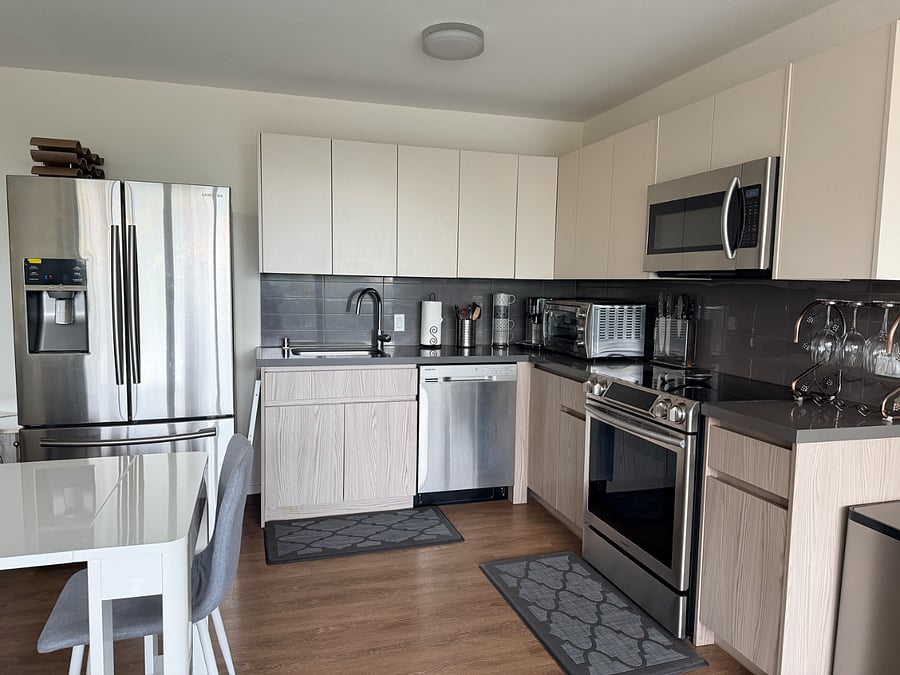 Samsung high energy efficient appliances (includes- refrigerator, electric range, microwave hood, and dishwasher.) Sink with new disposal.  Super-automatic espresso machine, toaster oven, and kitchenware provided.
