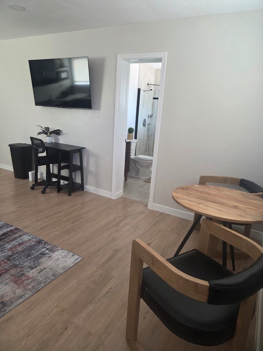 There is a computer desk and dining area
