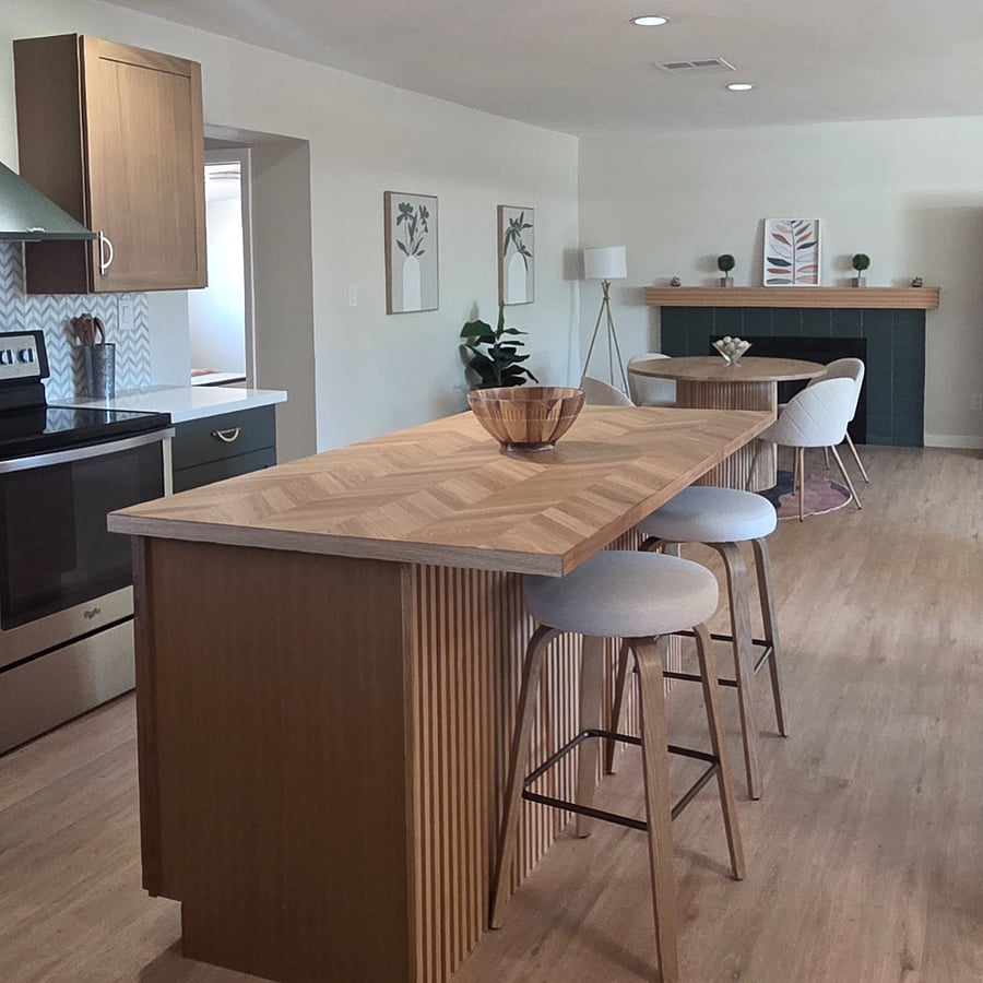Kitchen island with seating and view of dining area