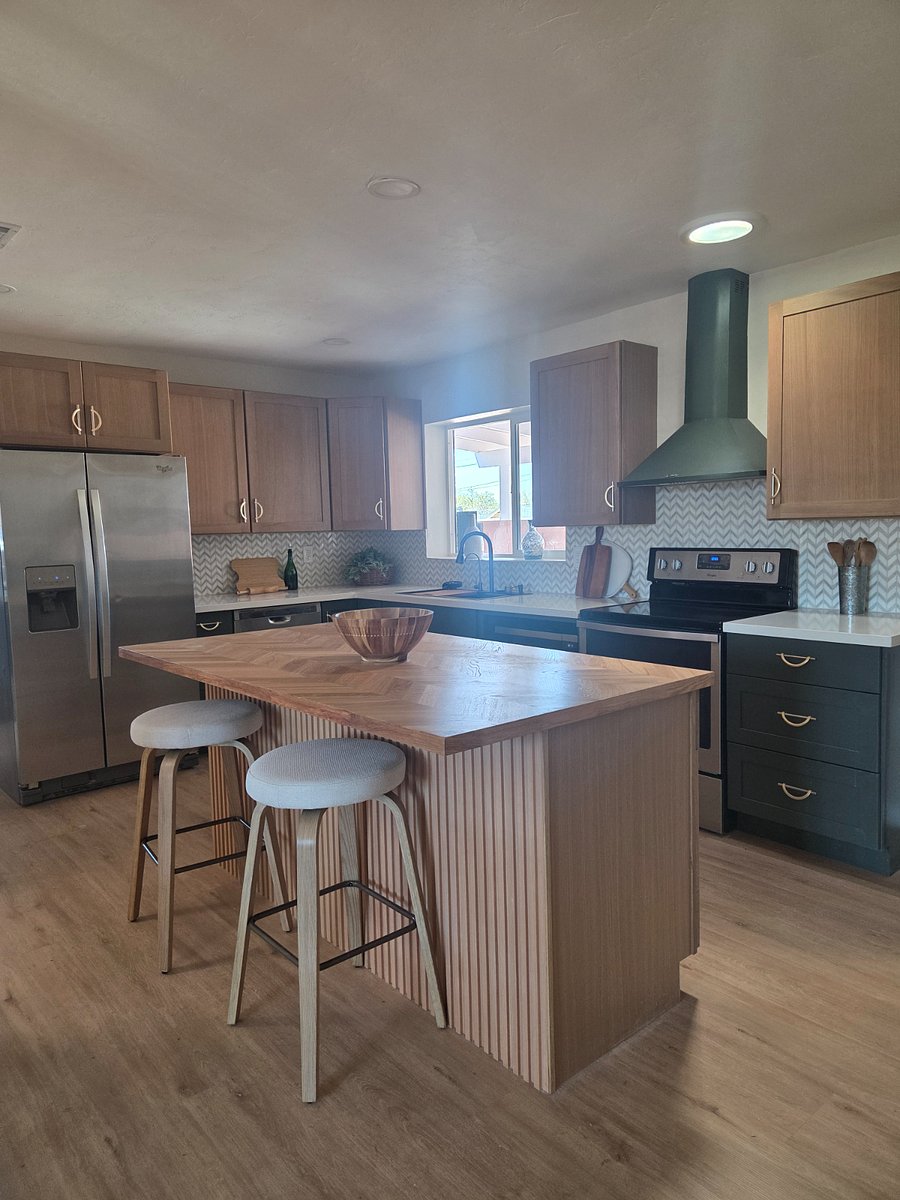 Another view or the kitchen showing white oak upper cabinets with fern green lower cabinets