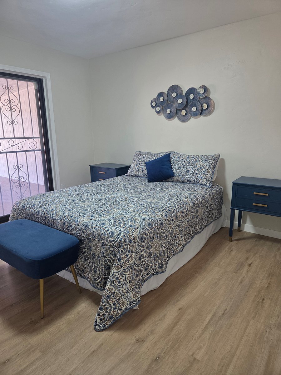 Master bedroom with sliding glass door to covered patio in the backyard