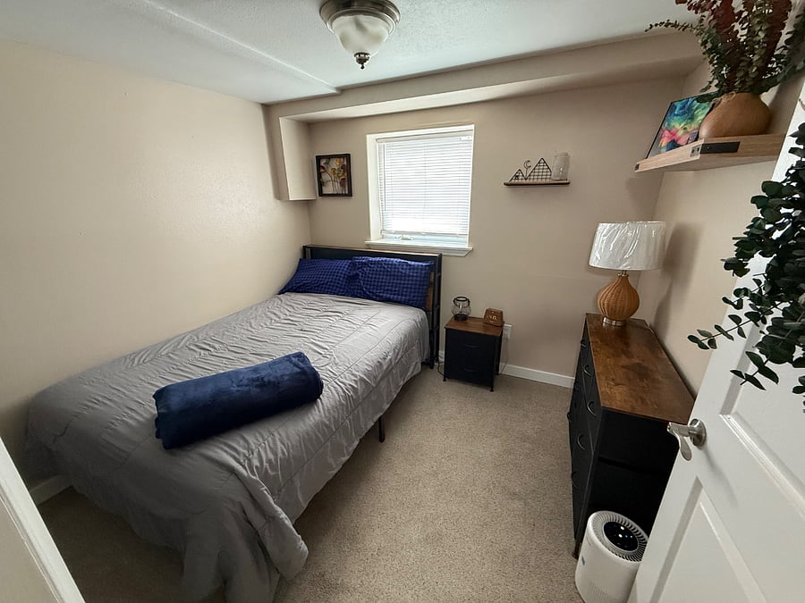 Large full size bed with headboard, plenty of dresser space with a nightstand.