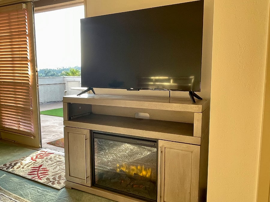 Smart TV and electric heater with cozy fireplace feel.