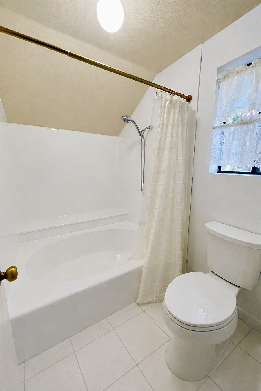 Freshly glazed delux soaking tub. New Kohler toilet. Marble floor.