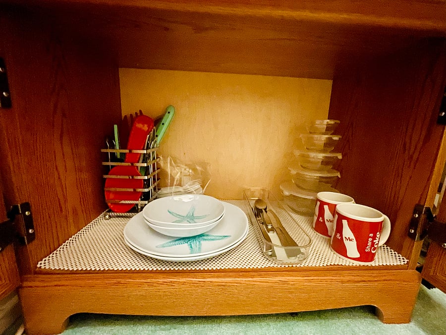 2 sets of plates, bowls, utensils, mugs, and cups provided.