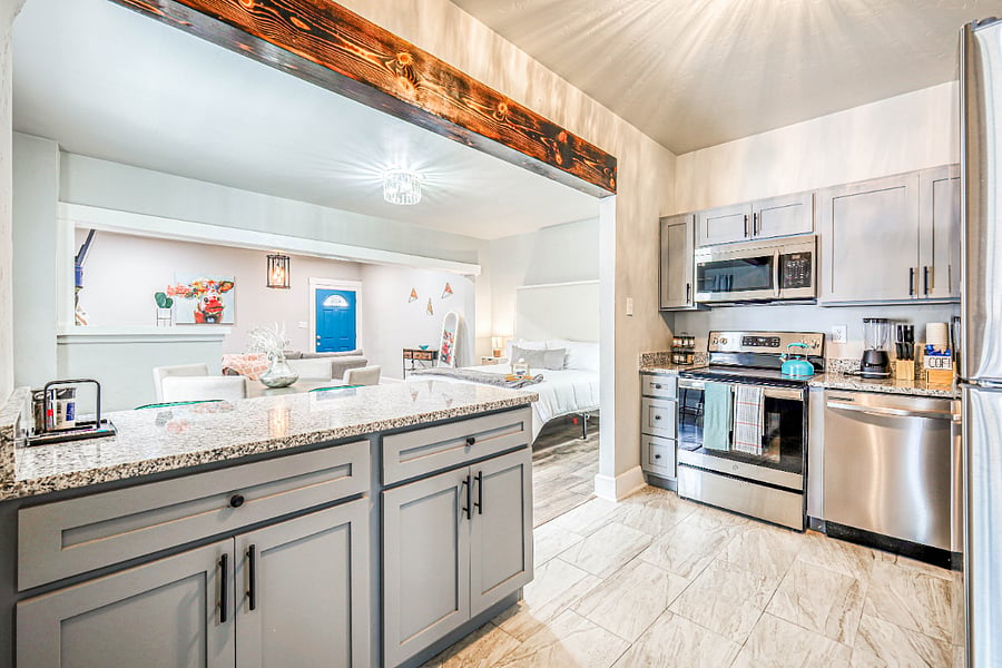 Full kitchen with stove, dishwasher, microwave & fridge